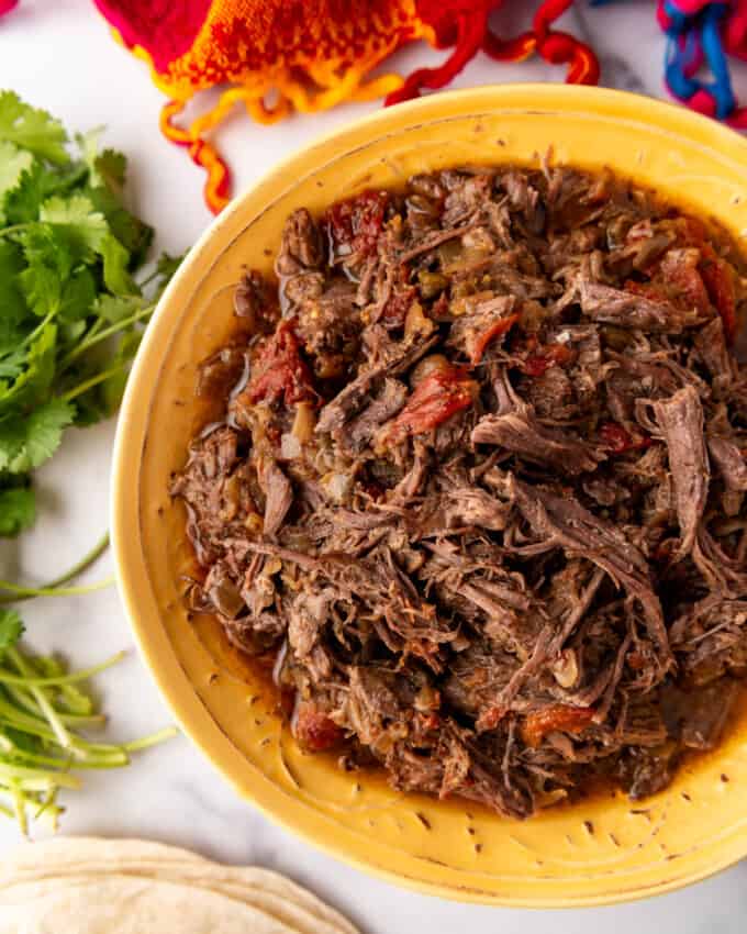 An overhead image of a bowl of Mexican shredded beef barbacoa.