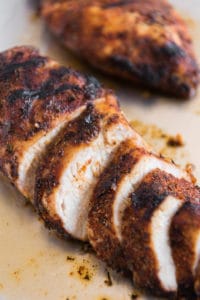 Grilled Cajun Chicken Breasts and one is sliced.