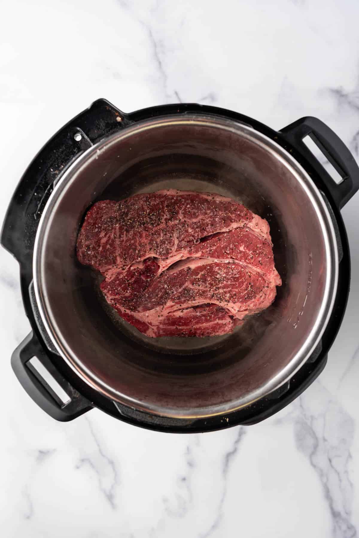 Searing a chuck roast in the Instant Pot.