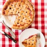 Strawberry Rhubarb Pie with a slice removed and placed on a plate to the side