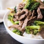 Beef with Broccoli on rice in a white bowl