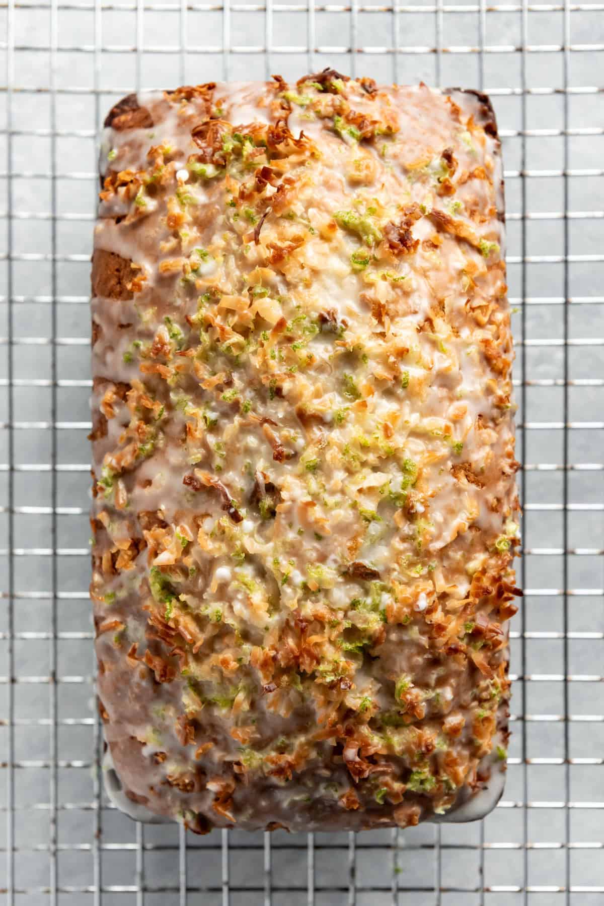 an aerial view of coconut lime banana bread on a wire rack