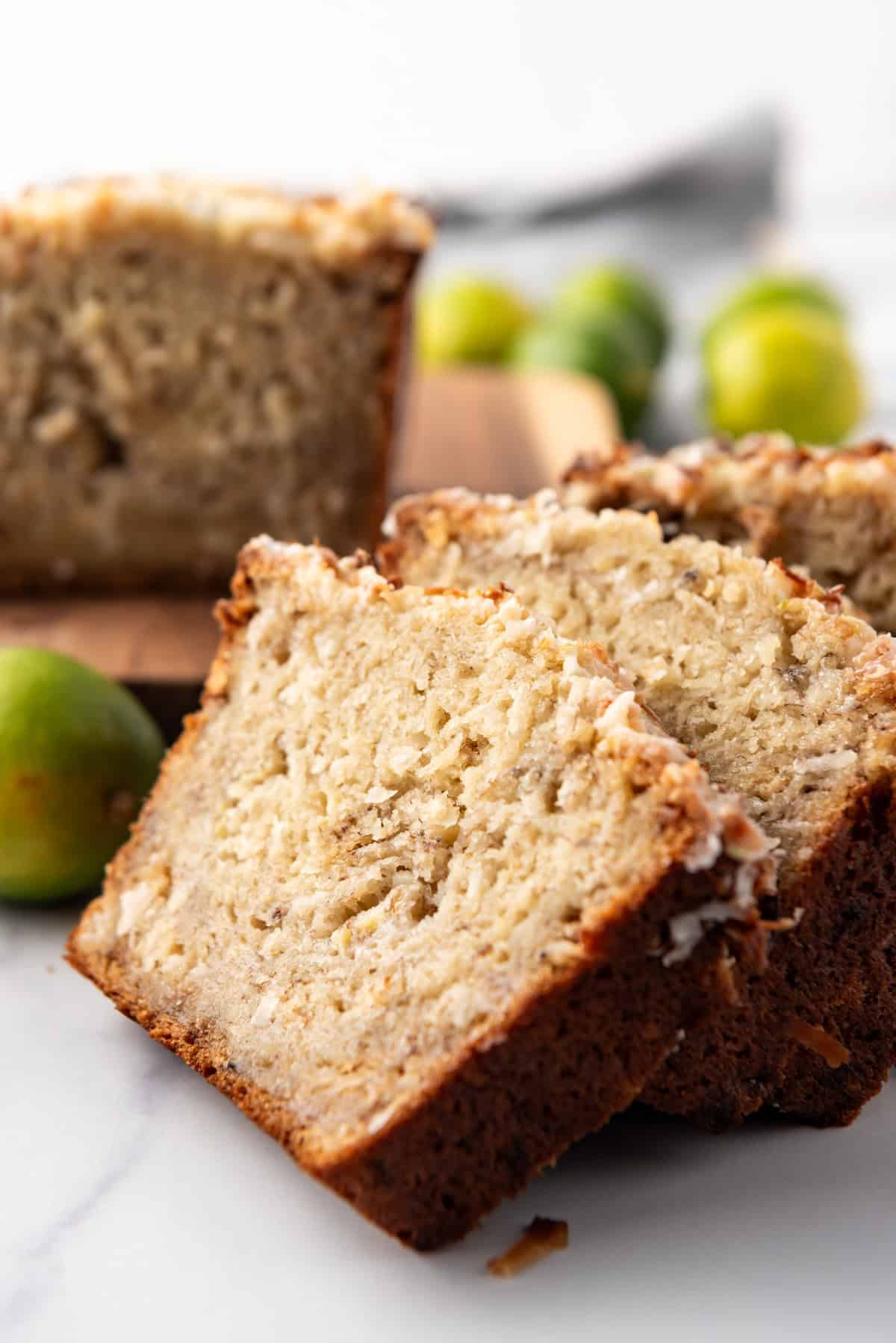 Slices of coconut lime banana bread leaning against each other.