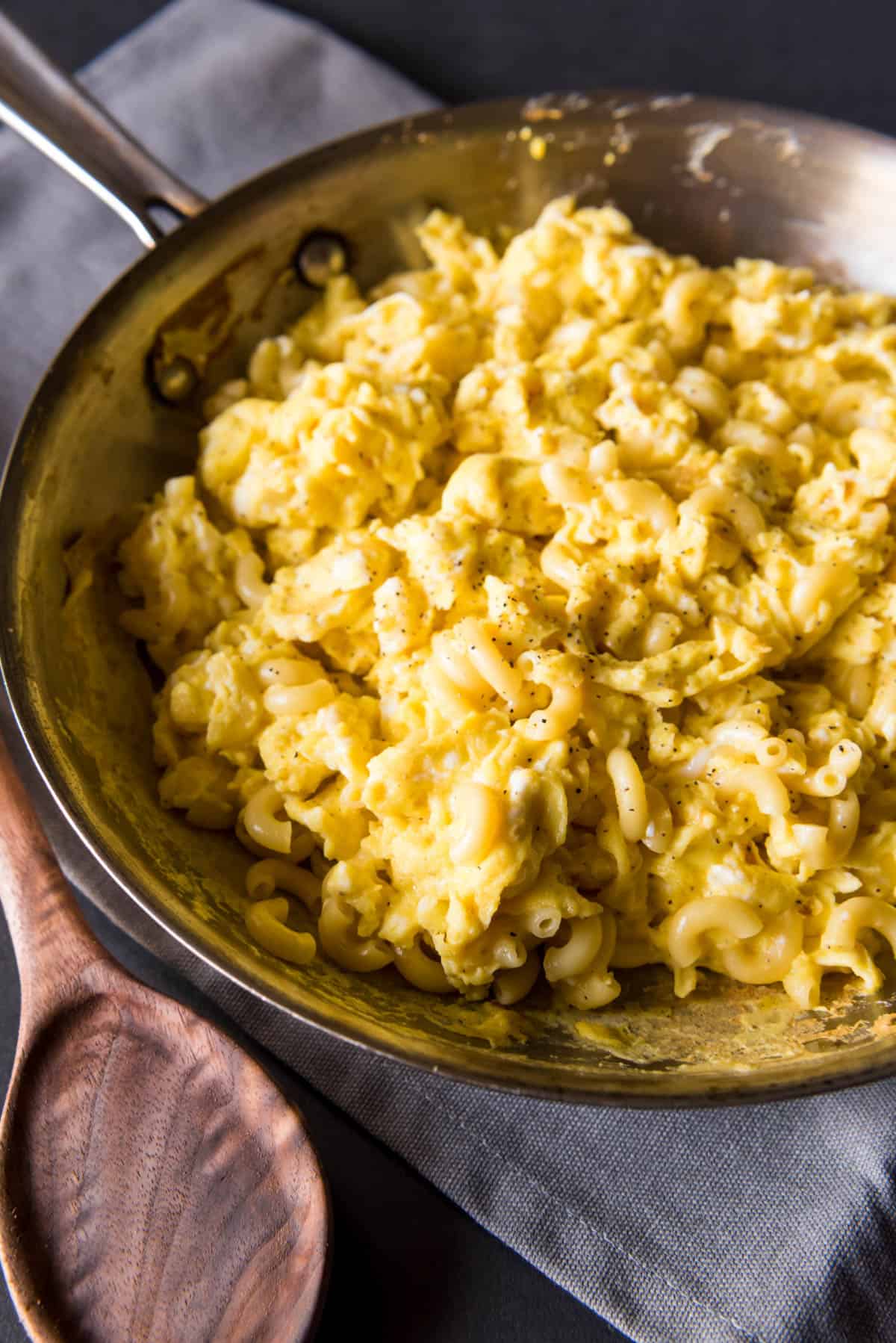 Scrambled eggs and pasta inside a skillet.