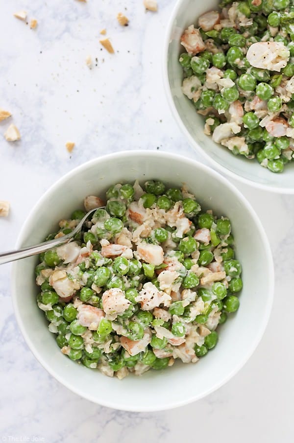 white bowls of shrimp and pea salad