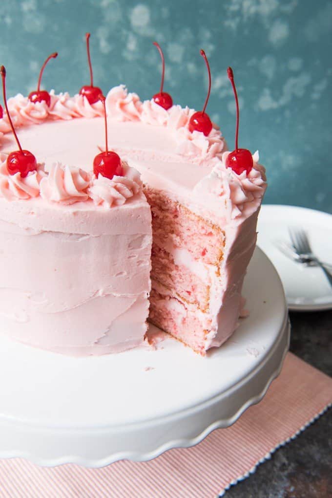 a slice peeking out from this vintage cherry chip cake