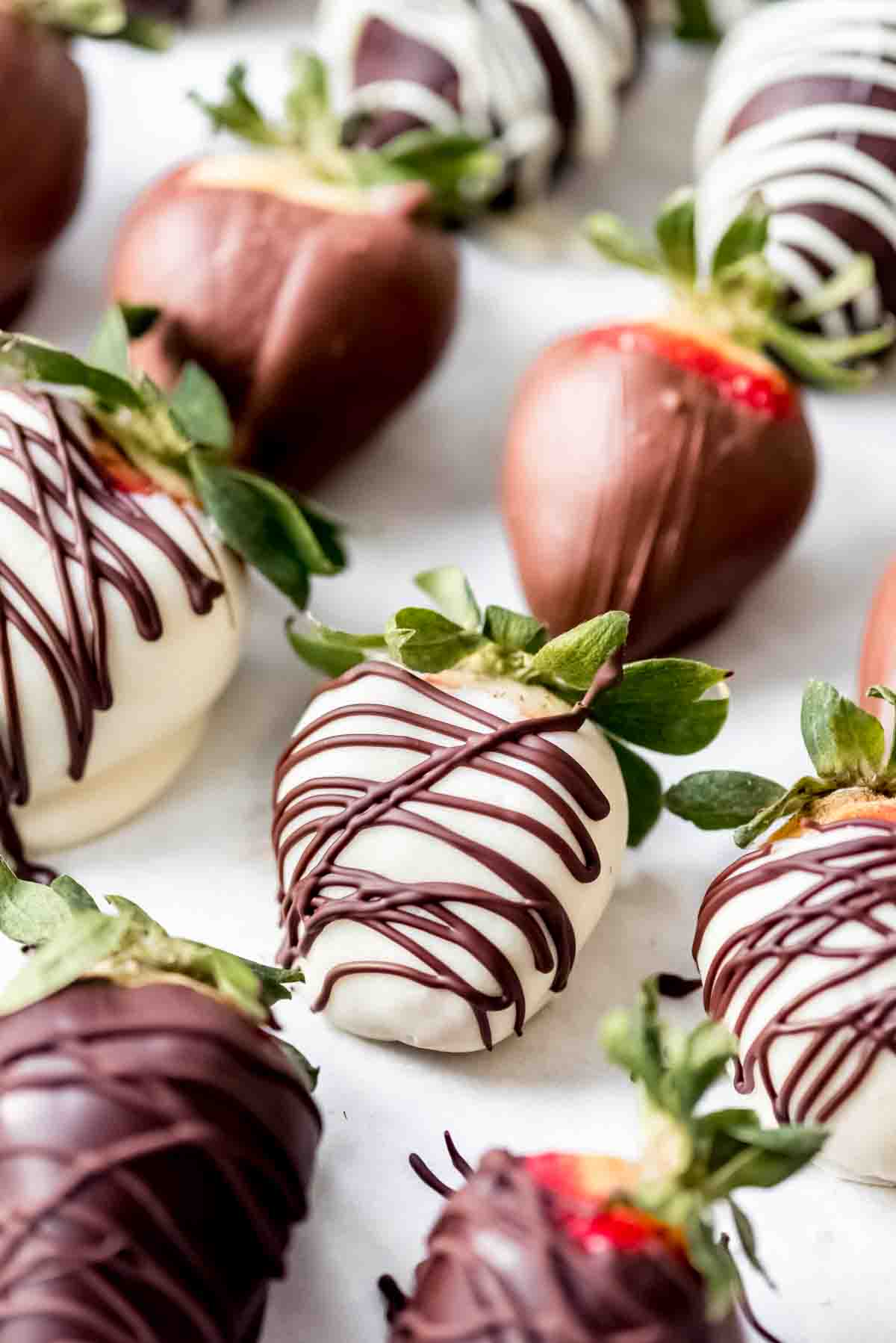 Strawberries covered in white chocolate with a dark chocolate drizzle.