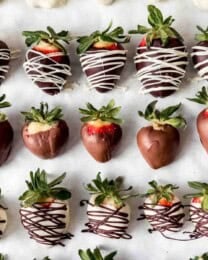 Rows of gourmet chocolate covered strawberries.