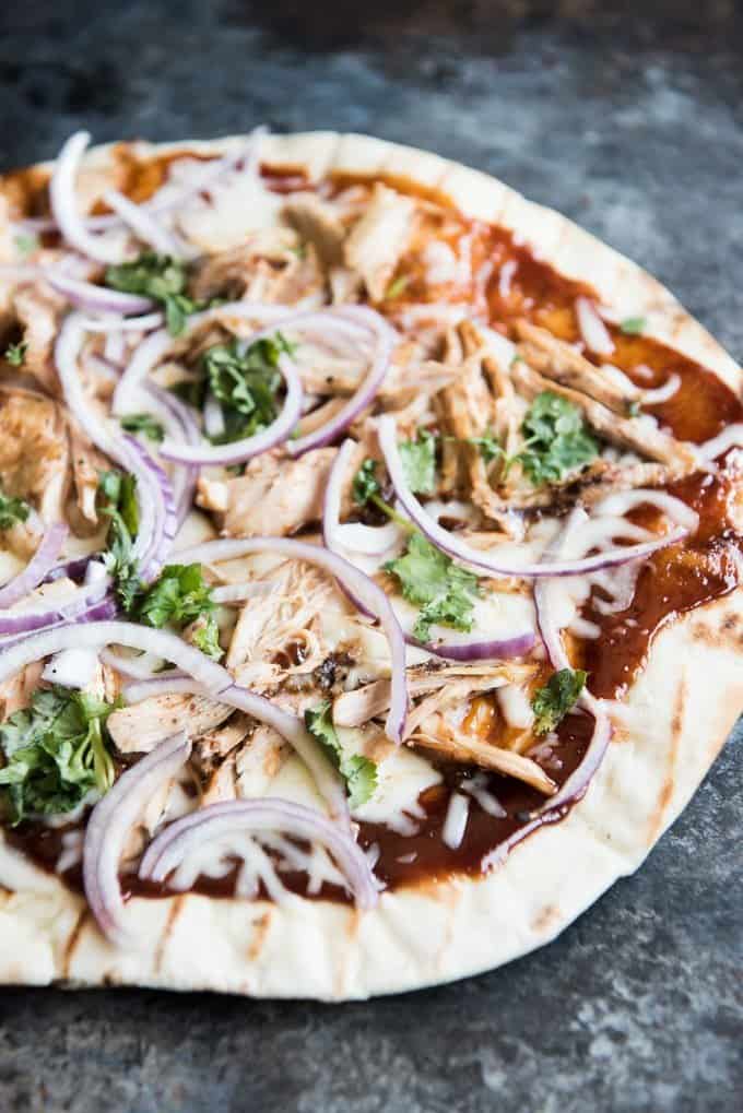 Grilled BBQ Chicken Pizza topped with onions, chicken, sauce and cheese