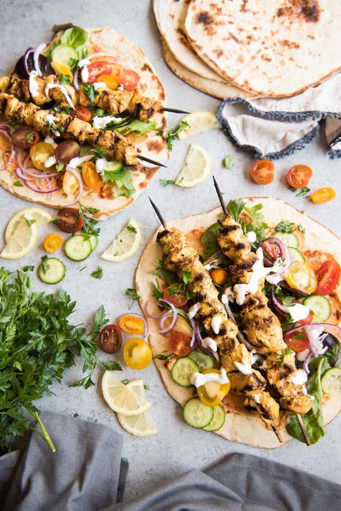 Grilled Chicken Shawarma Wraps are inspired by middle eastern street food where chicken is marinated in spices and then roasted on a spit to perfection and wrapped up in flatbread for a delicious sandwich.  Beats takeout or fast food any day!