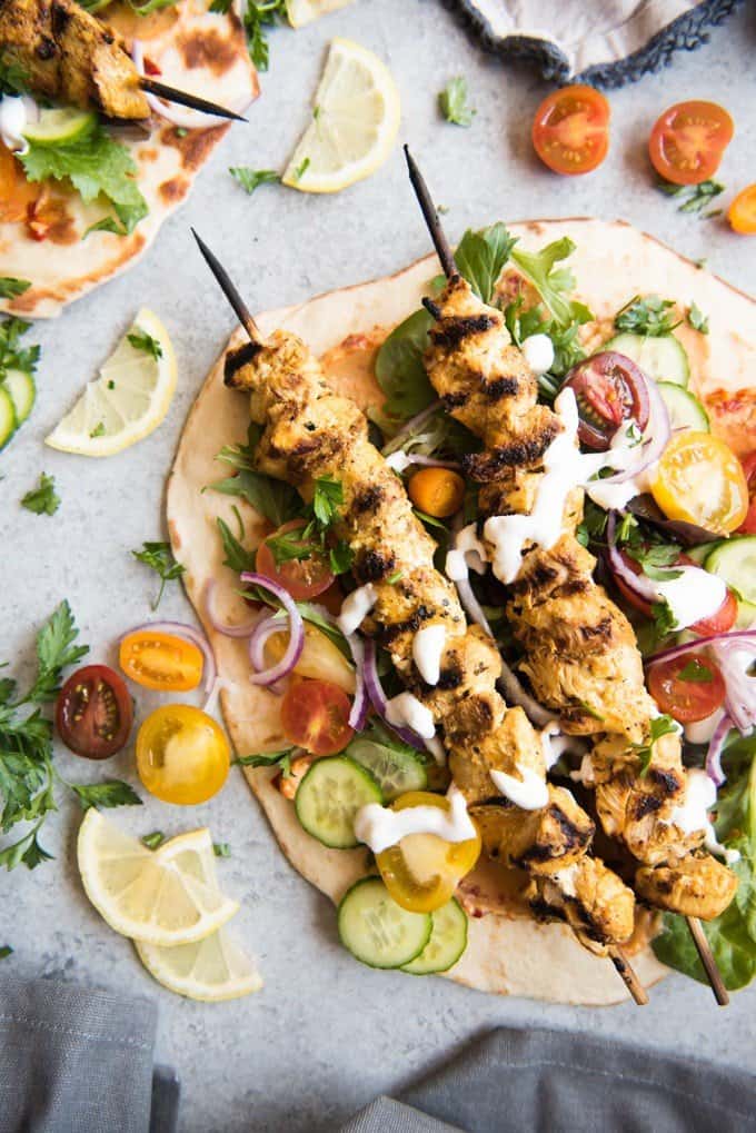 Grilled Chicken Shawarma Wraps are inspired by middle eastern street food where chicken is marinated in spices and then roasted on a spit to perfection and wrapped up in flatbread for a delicious sandwich.  Beats takeout or fast food any day!