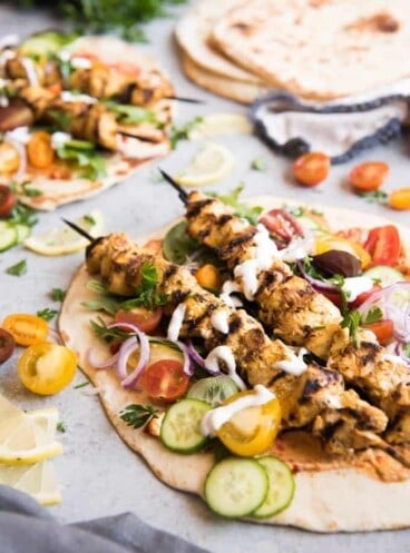 Grilled Chicken Shawarma Wraps are inspired by middle eastern street food where chicken is marinated in spices and then roasted on a spit to perfection and wrapped up in flatbread for a delicious sandwich.  Beats takeout or fast food any day! Perfect for salads as well!