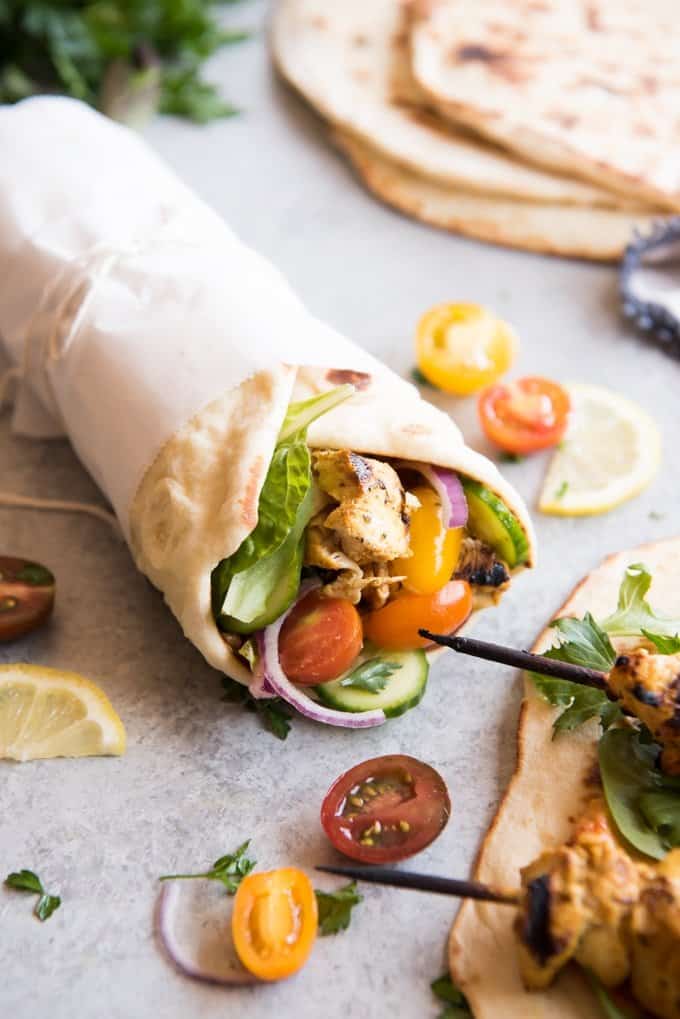 Grilled Chicken Shawarma Wraps are inspired by middle eastern street food where chicken is marinated in spices and then roasted on a spit to perfection and wrapped up in flatbread for a delicious sandwich.  Beats takeout or fast food any day! Perfect for salads as well!