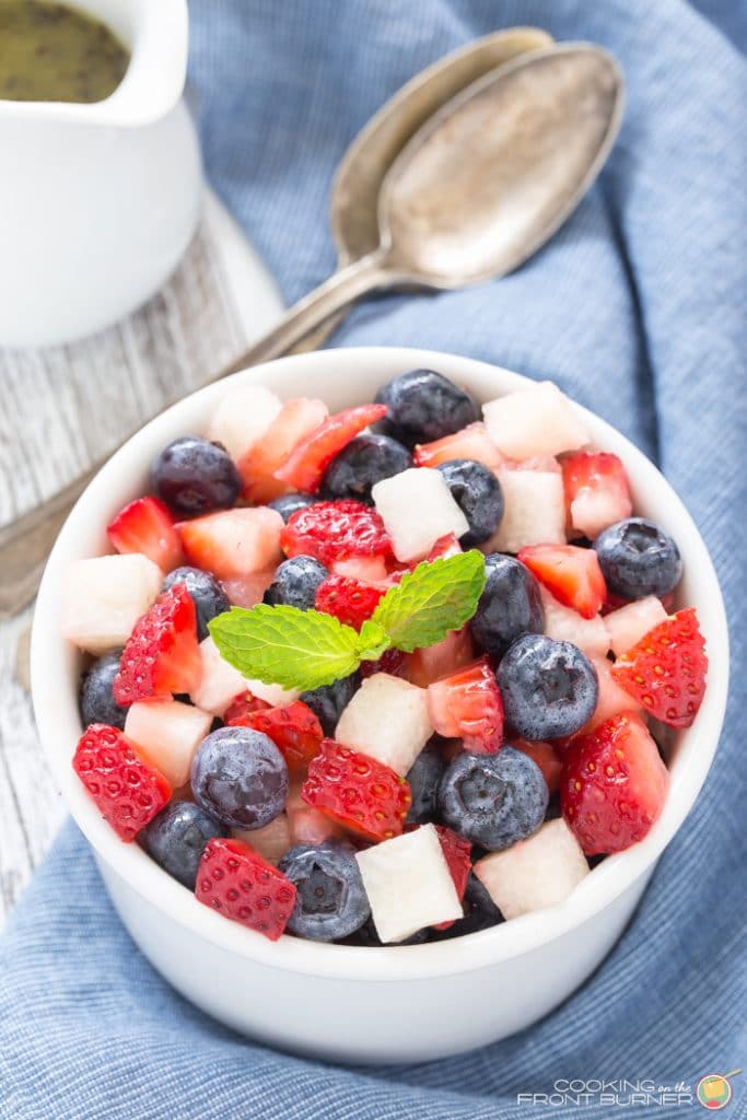 a white bowl of strawberry blueberry jimica salad