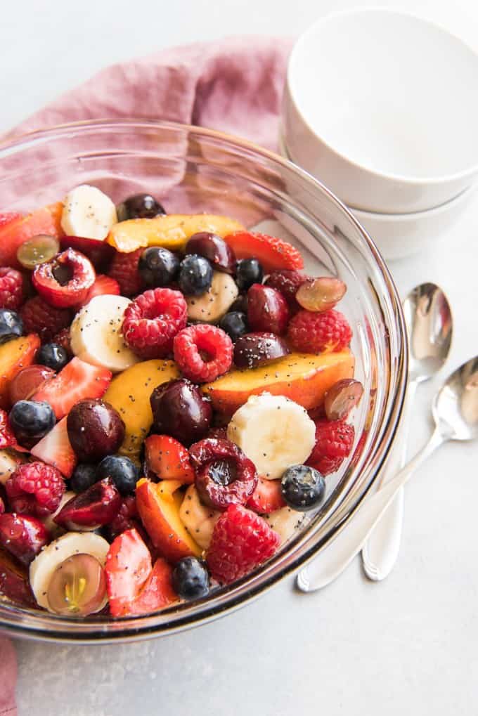 a glass bowl of poppyseed fruit salad