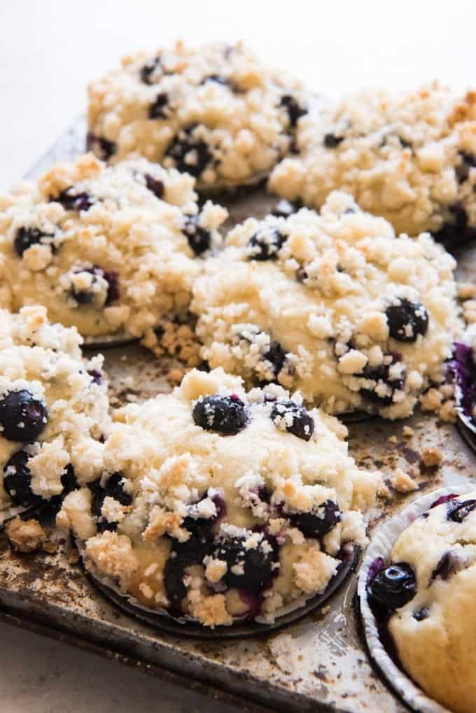 an upclose view of blueberry streusel muffins in a muffin pan