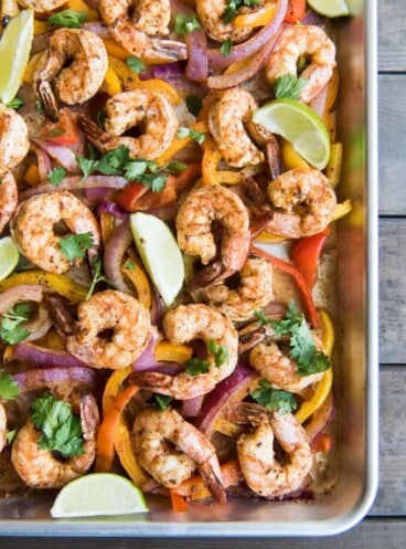 a corner of a baking sheet filled with the shrimp fajitas filling