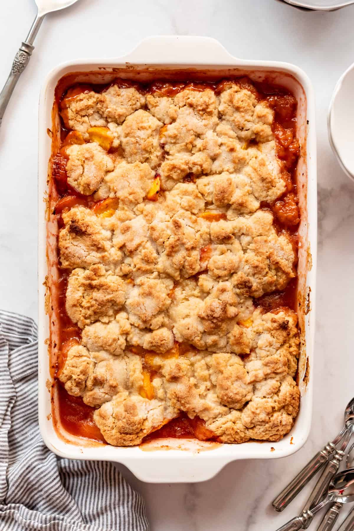 An overhead image of a baked peach cobbler.