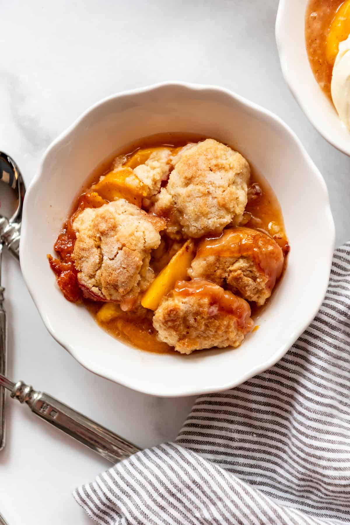 An overhead image of a bowl of peach cobbler.