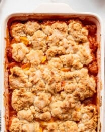 An overhead image of a baked peach cobbler.