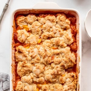 An overhead image of a baked peach cobbler.