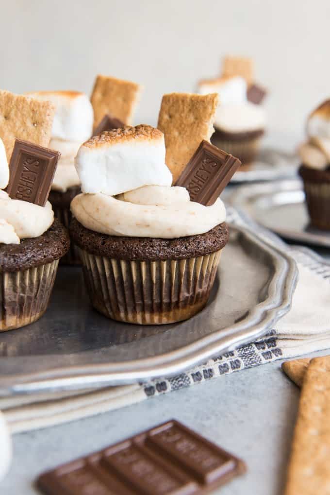 smores marshmallows on plates with graham crackers chocolate bars and toasted marshmallows