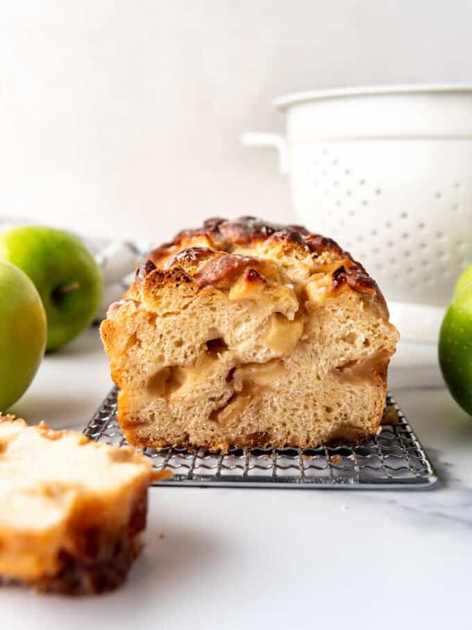 Sliced apple fritter bread on a wire rack.