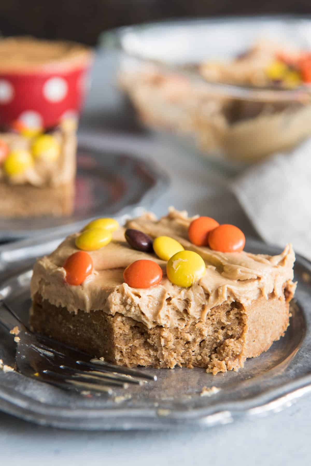 A slice of peanut butter blondie with peanut butter candies on top .