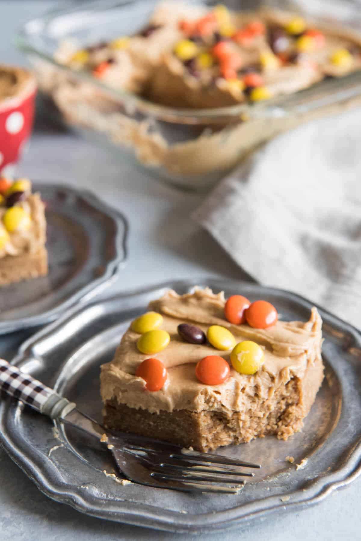 A peanut butter blondie on a plate with a fork.