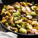 Roasted Brussels Sprouts with Bacon and Apples in a cast iron skillet