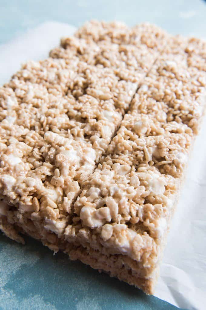 An image of a batch of rice krispy treats cut into squares.
