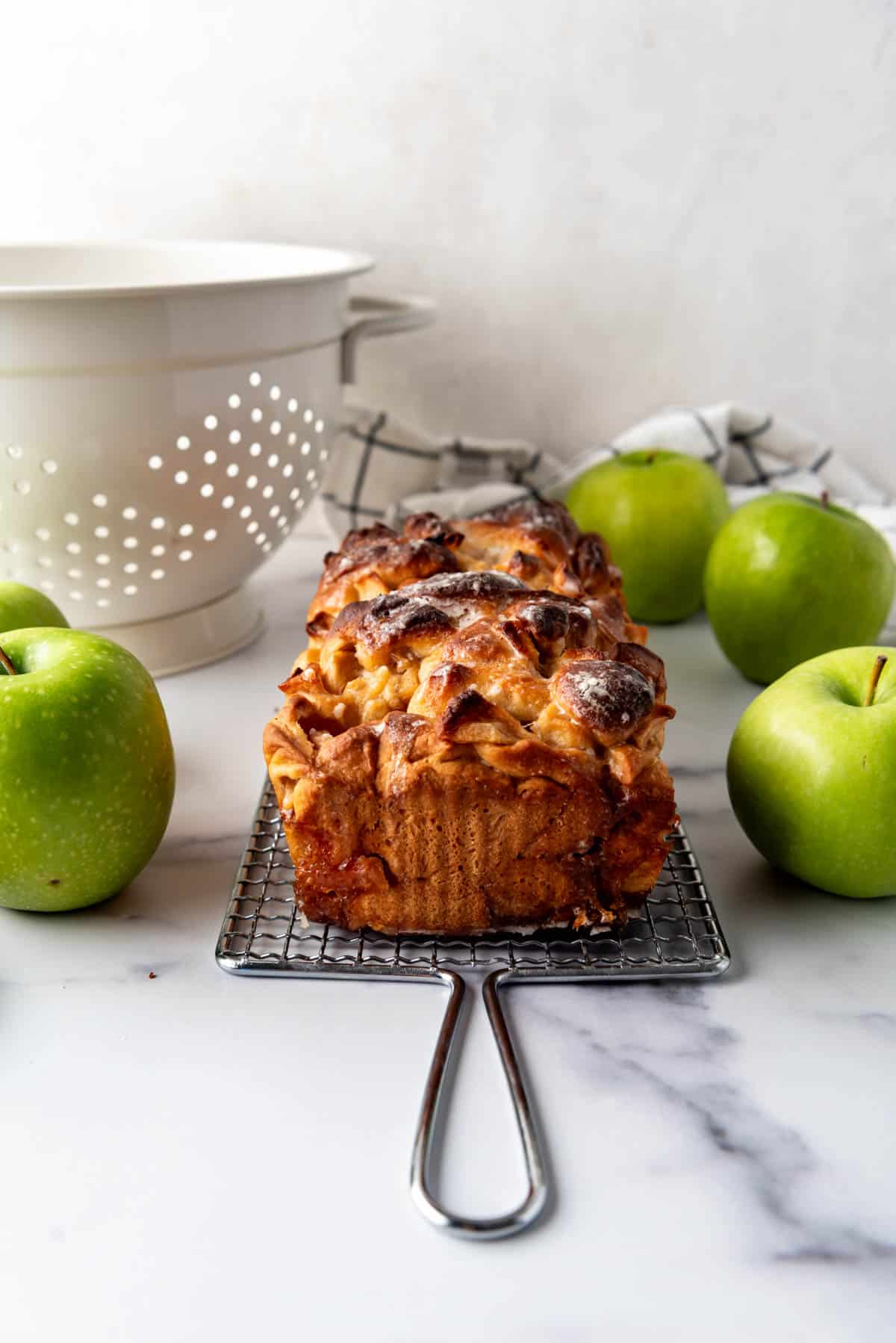 A finished, glazed loaf of apple bread dough.