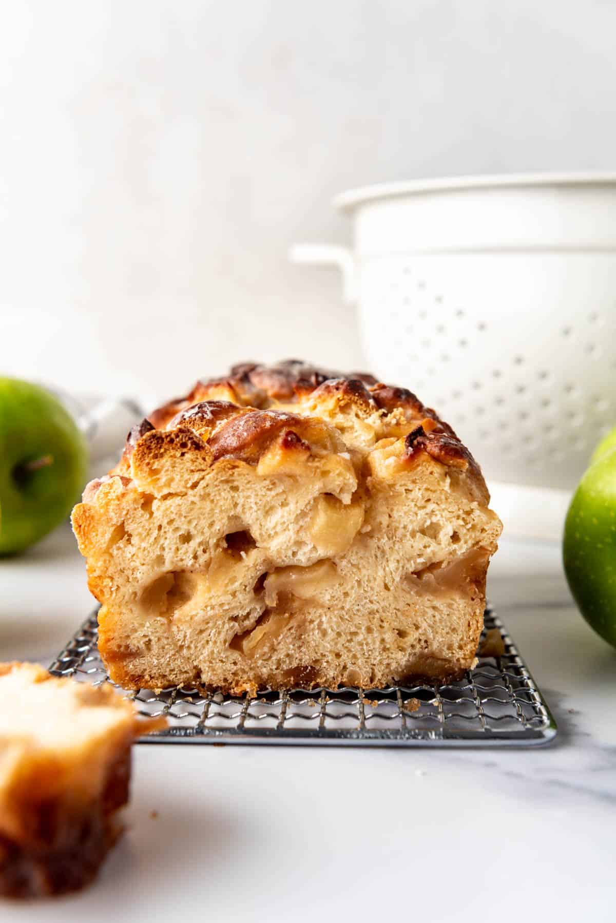 Sliced apple fritter bread on a wire rack.