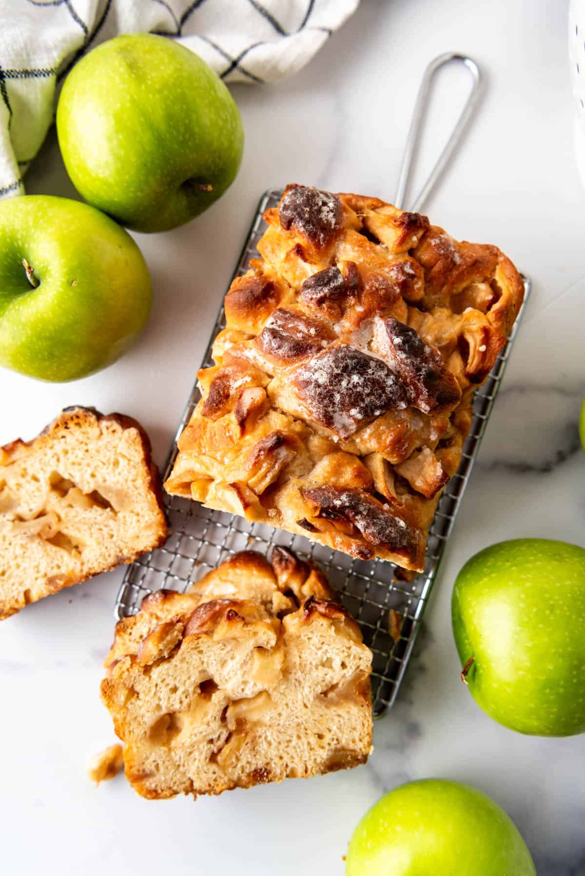 An overhead image of a sliced loaf of apple fritter bread.