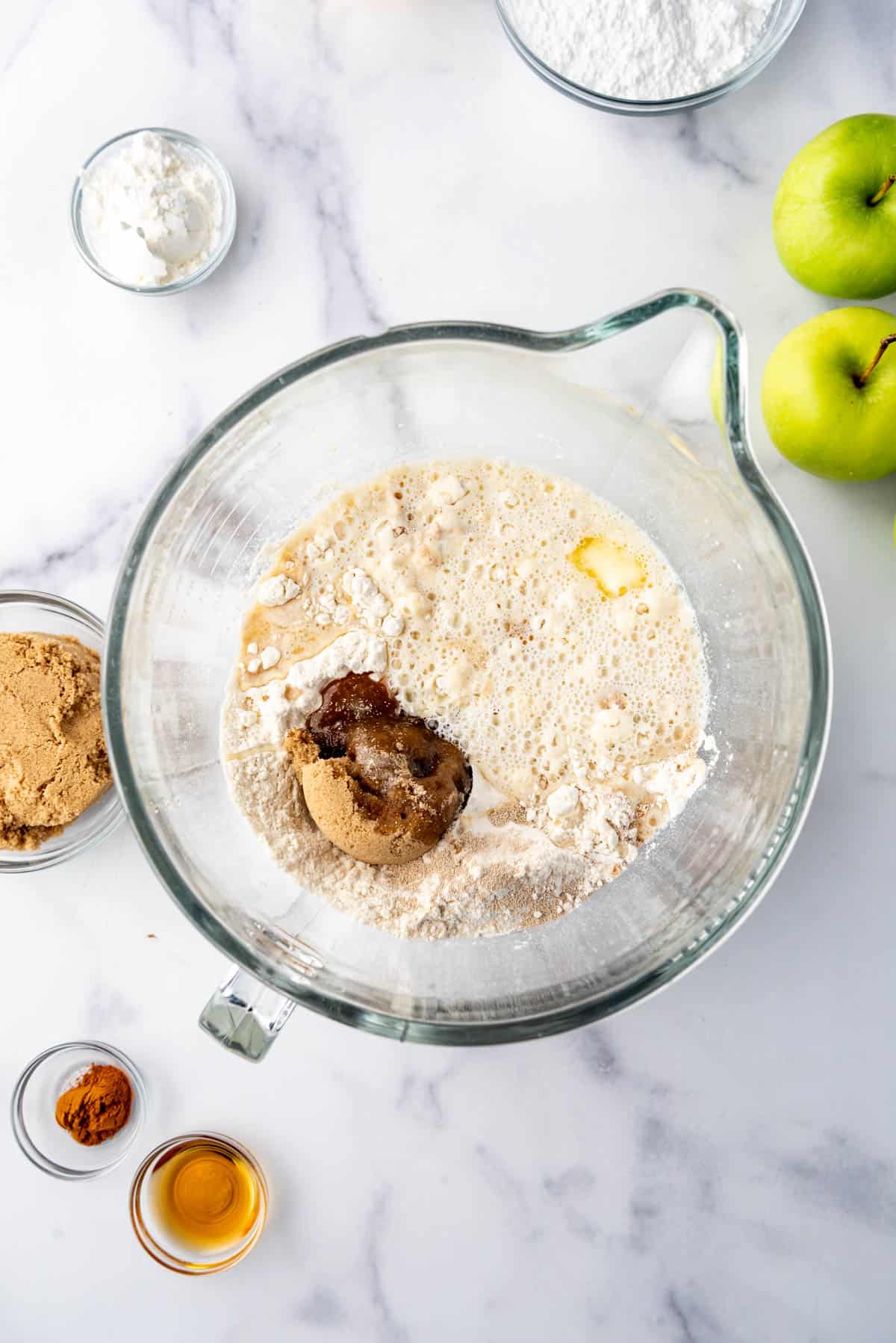 Combining ingredients to make apple fritter bread.