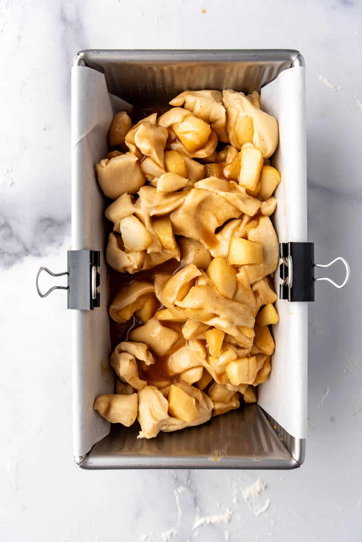 Unbaked apple fritter bread dough in a bread pan.