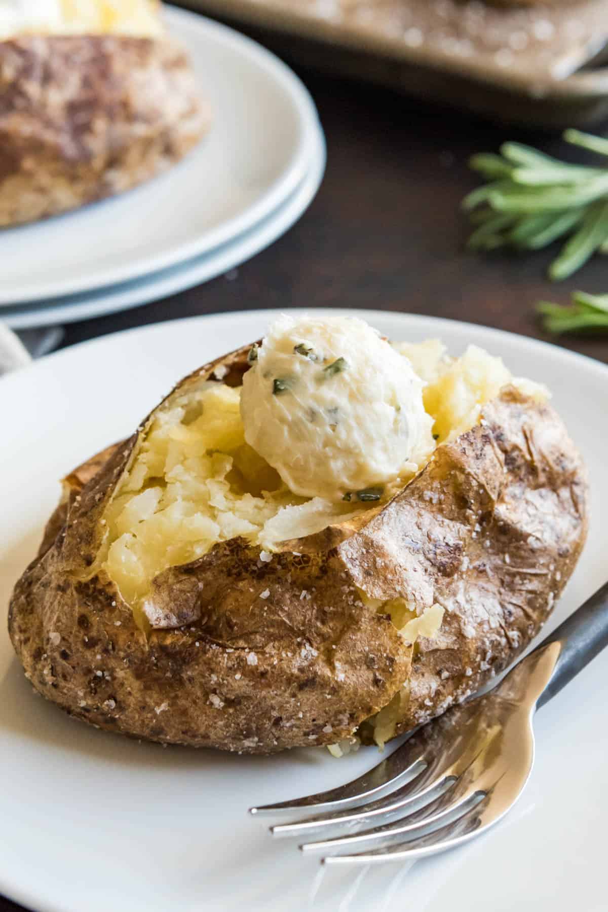 Garlic and rosemary butter topped salted baked potato.