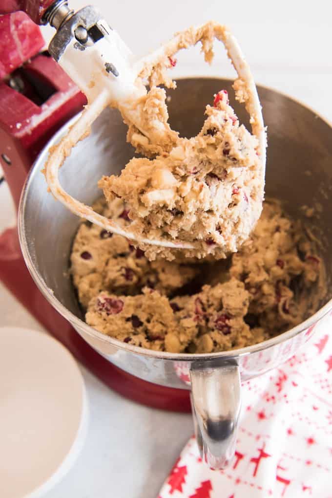 Red kitchen stand mixer with a bowl full of white chocolate cranberry blondie batter.