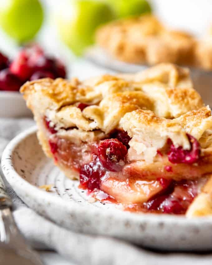 A close up image of cranberry apple pie on a plate.