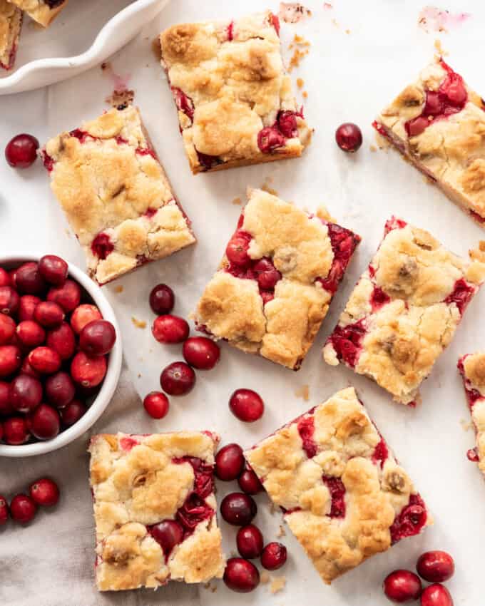 Cranberry shortbread bars surrounded by fresh cranberries.