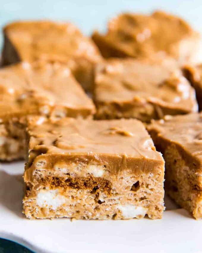 Squares of krispie treats on a white plate.