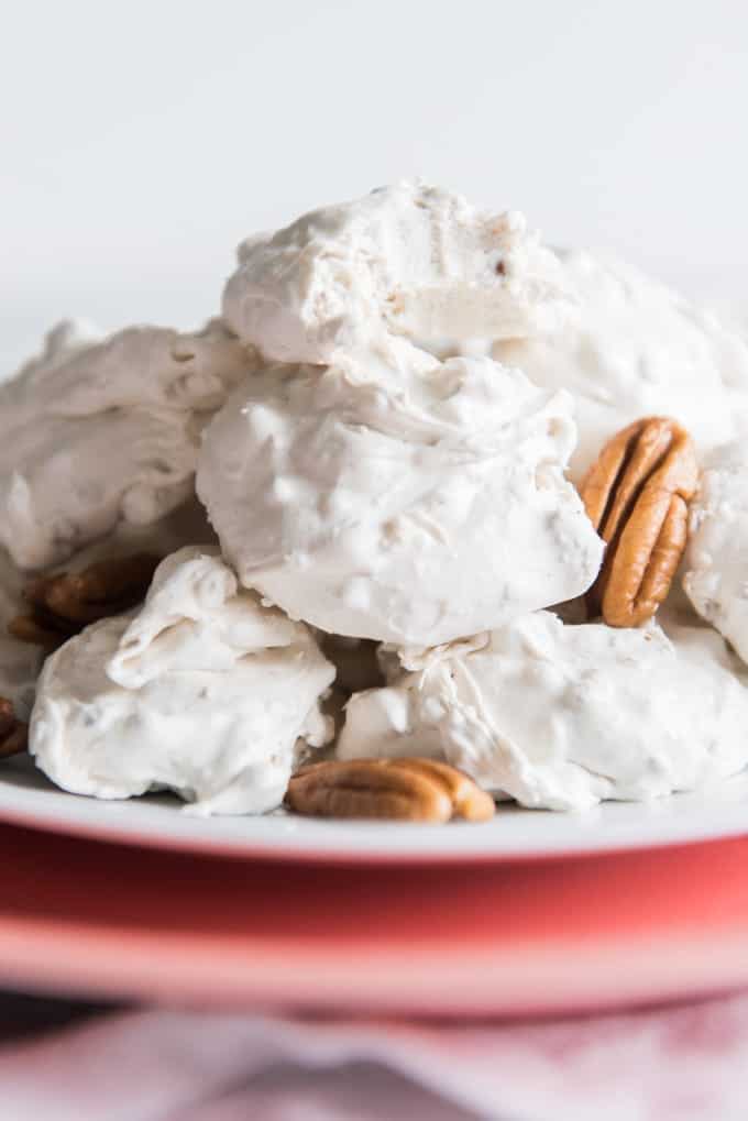 piled white divinity on a plate with pecans