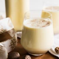 Light, creamy, and spiced with freshly grated nutmeg, this non-alcoholic Old Fashioned Homemade Eggnog is so, SO much better than the store-bought variety that shows up in cartons each year around November or December.  It is both a beloved and beleaguered holiday beverage with a fascinating history.