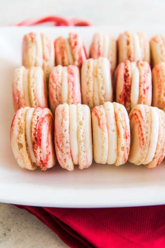 rows of peppermint macarons on white plate