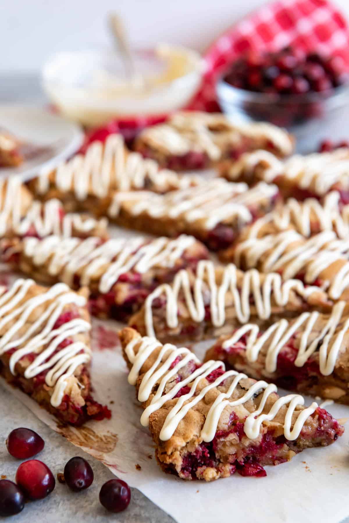 White chocolate cranberry blondies cut into triangles.