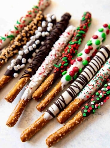 Chocolate covered pretzels decorated differently and festively.