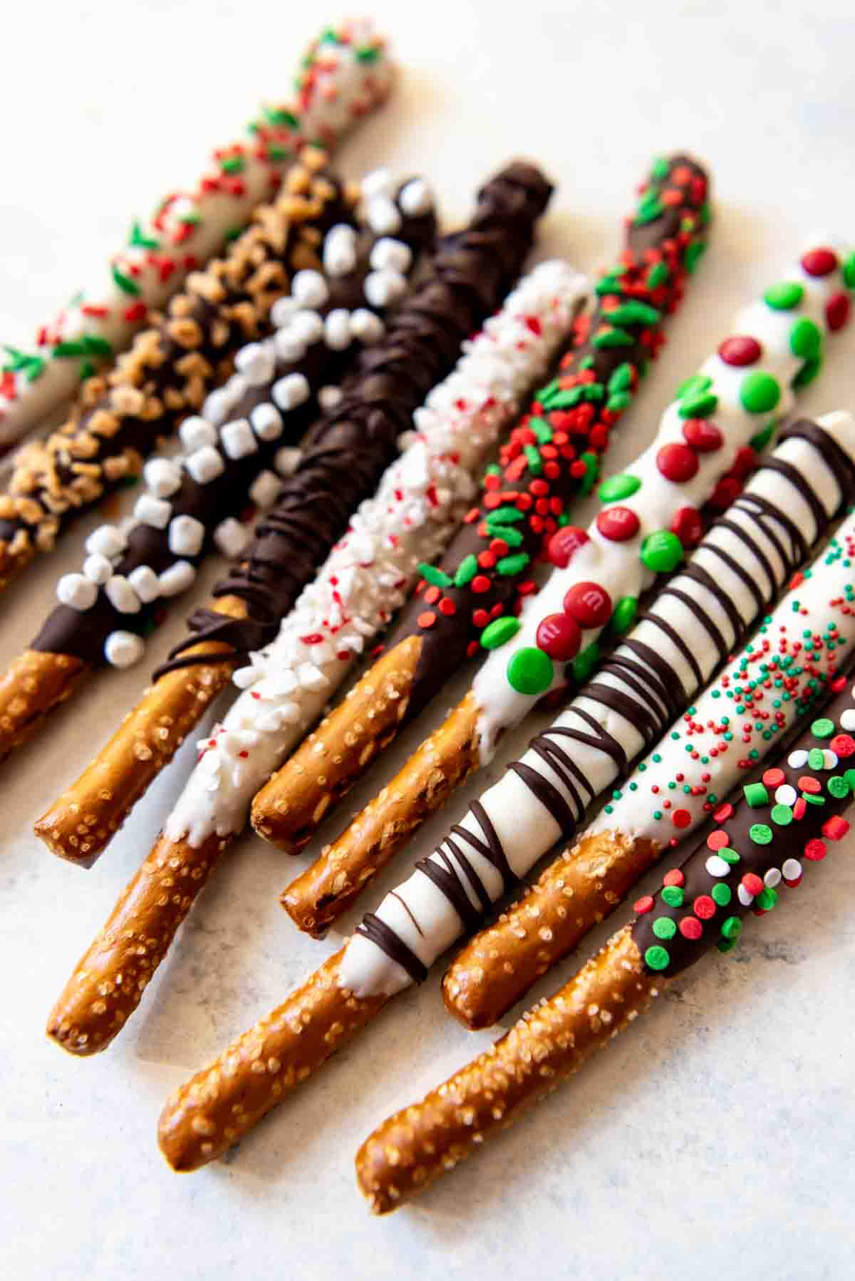 Chocolate covered pretzels decorated differently and festively.