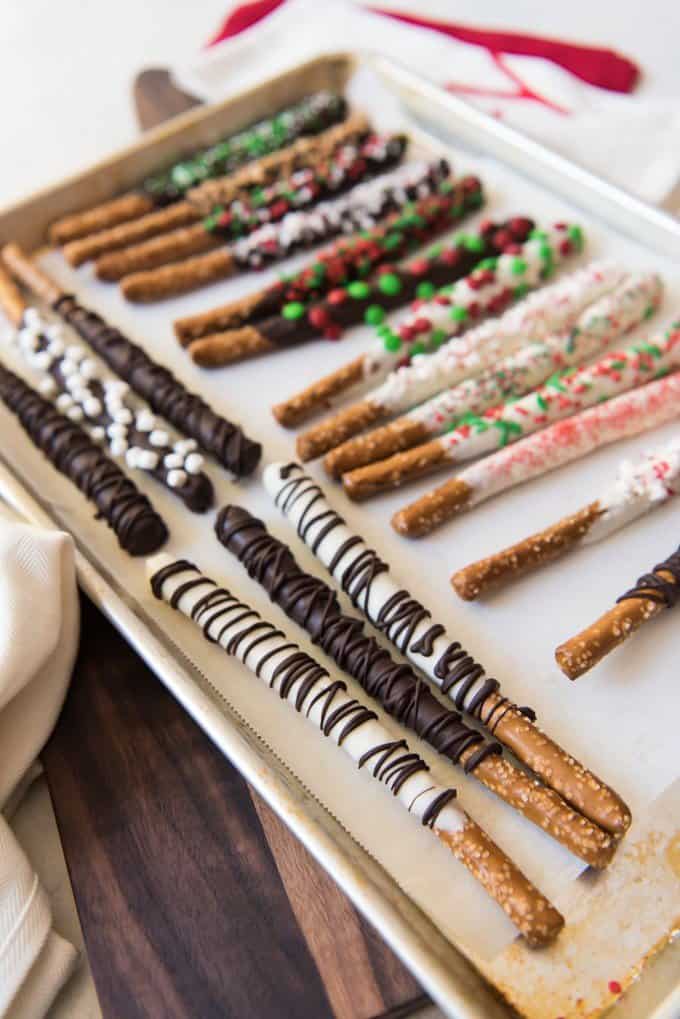 chocolate covered pretzels decorated and on a baking sheet