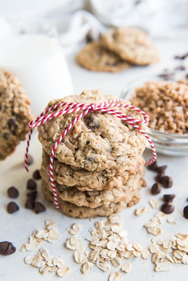 stacked toffee oatmeal chocolate chip cookies tied with a red and white ribbon