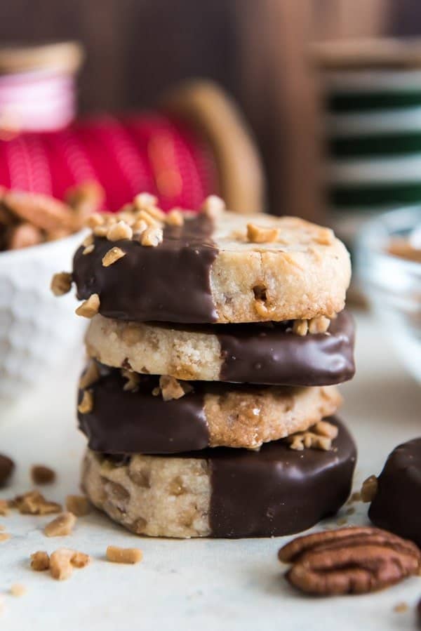 Stack of Chocolate-Dipped Toffee Pecan Shortbread Cookies for the Christmas holiday gift-giving of food as presents to neighbors and friends.